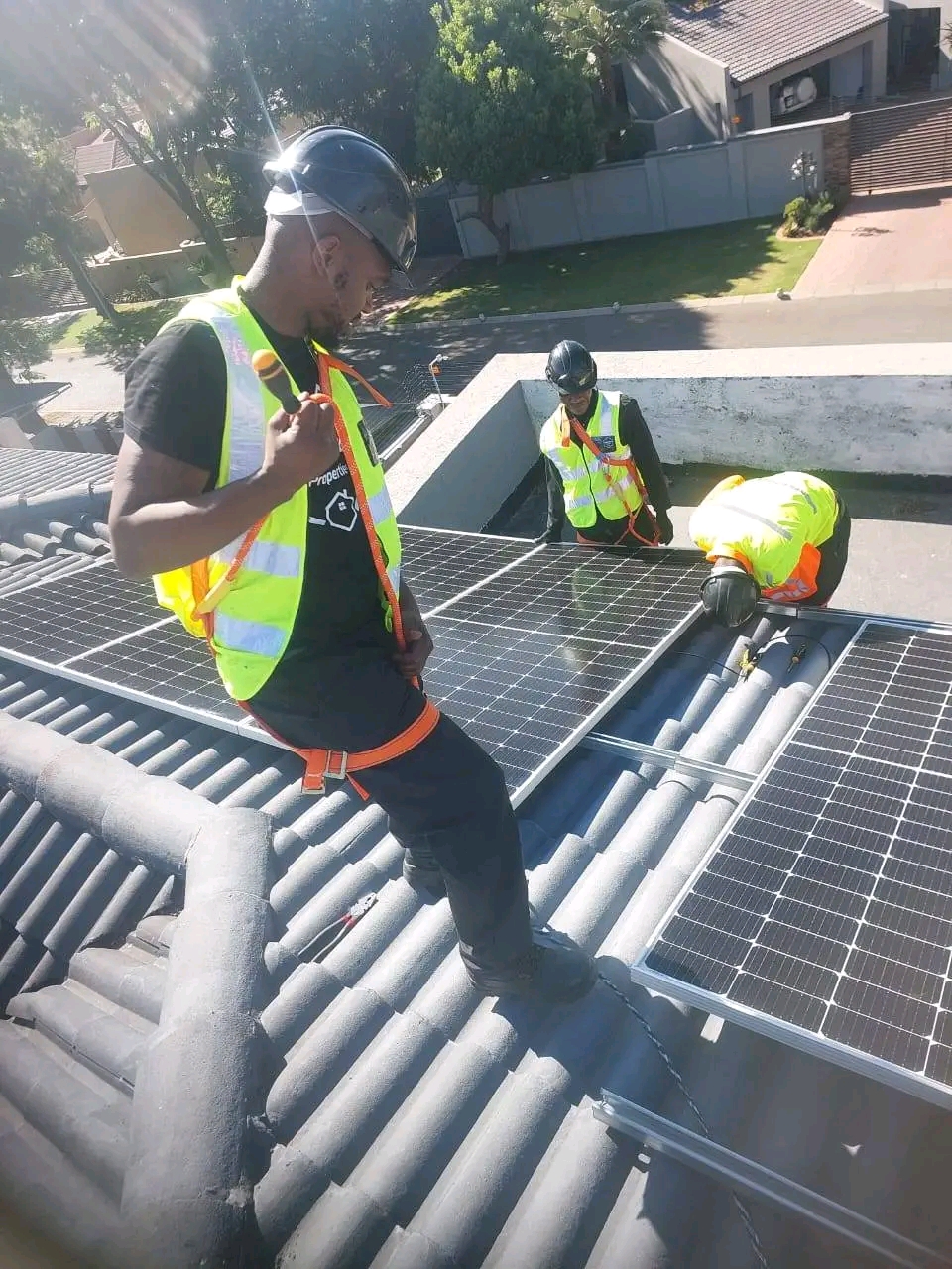 TC Electrical & Soulex Solar technicians installing solar panels on a rooftop