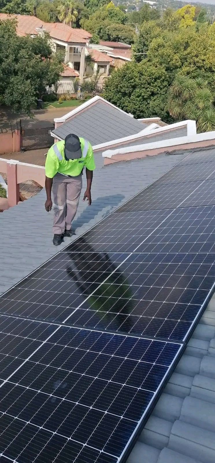 TC Electrical team working on a residential solar panel array